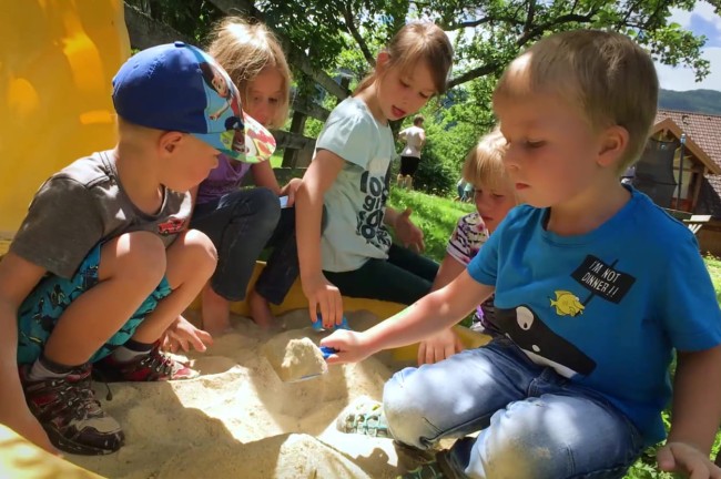 Playing with siblings and friends in the sandbox